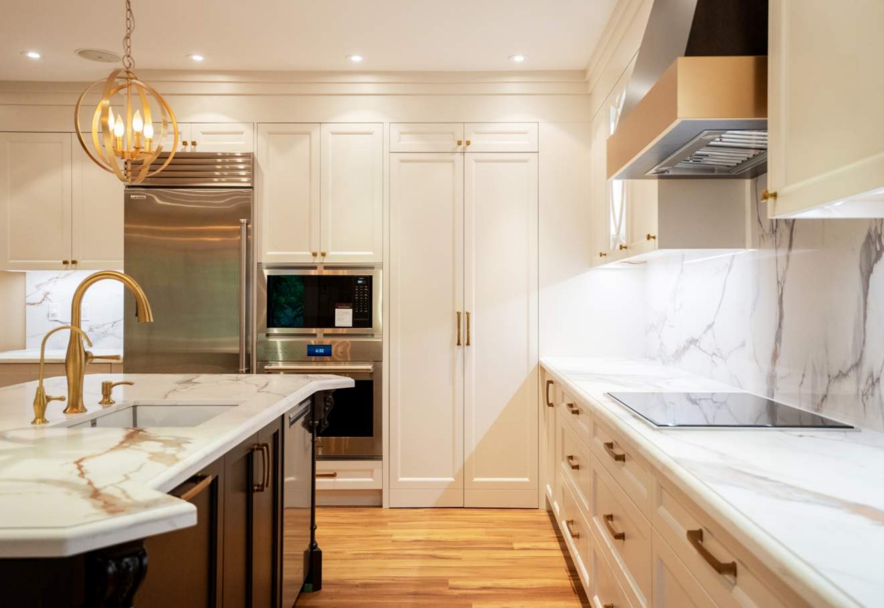 Integrated appliance wall with panelled cabinetry and wall ovens